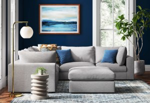 Sectional sofa in a living room with dark blue walls