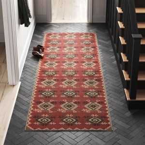 Hallway with a red area rug on a tile floor